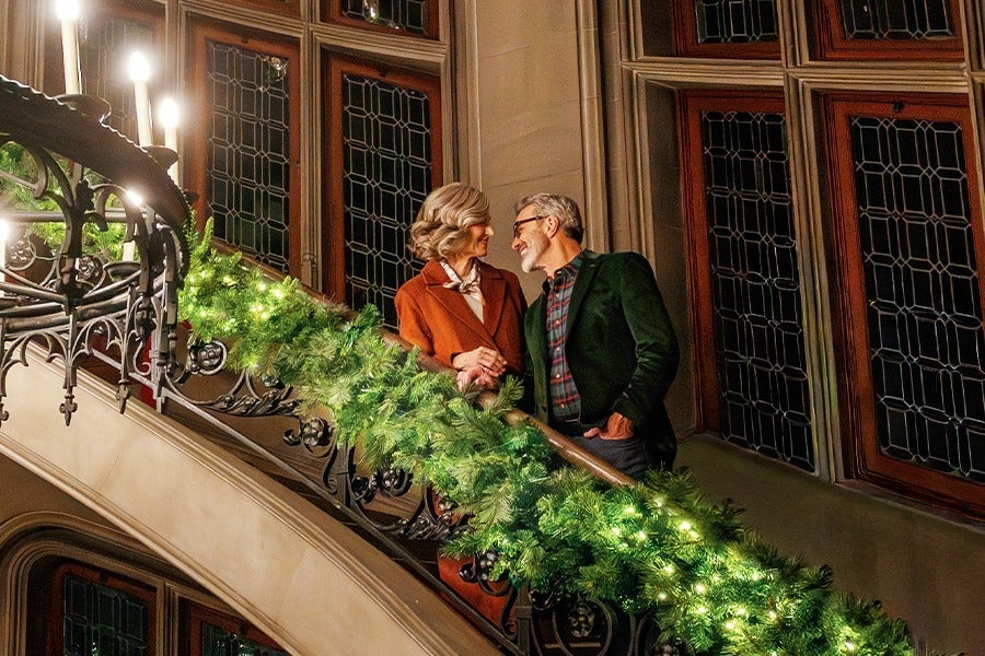 couple on Biltmore House staircase during Christmas