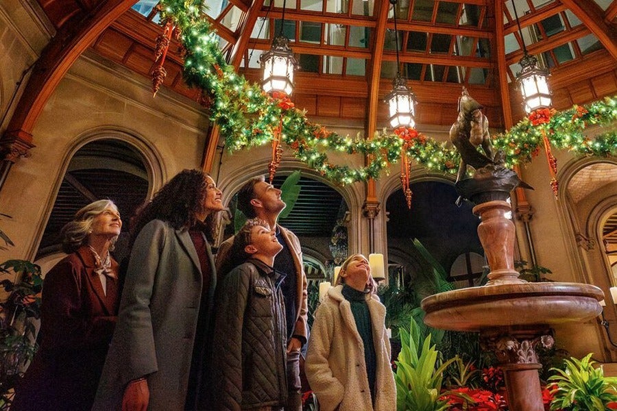 family enjoying Winter Garden in Biltmore House during Christmas