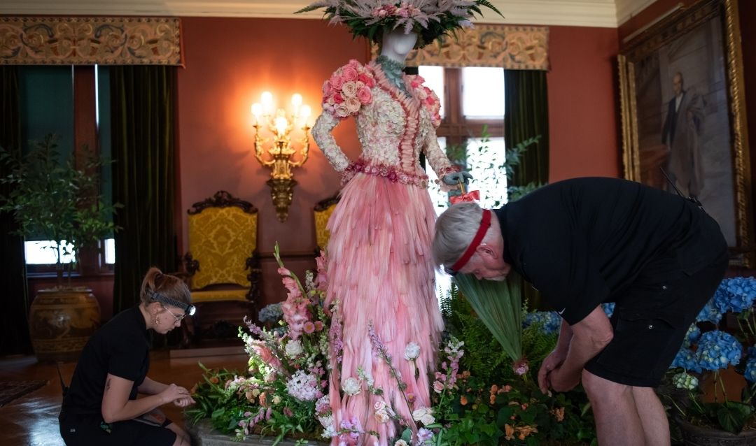 Staff members work on a Gibson Girl floral mannequin in Biltmore House