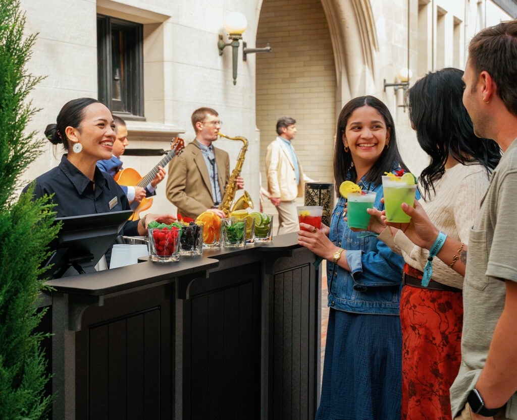 guests enjoying vibrant cocktails at the courtyard bar during Luminere