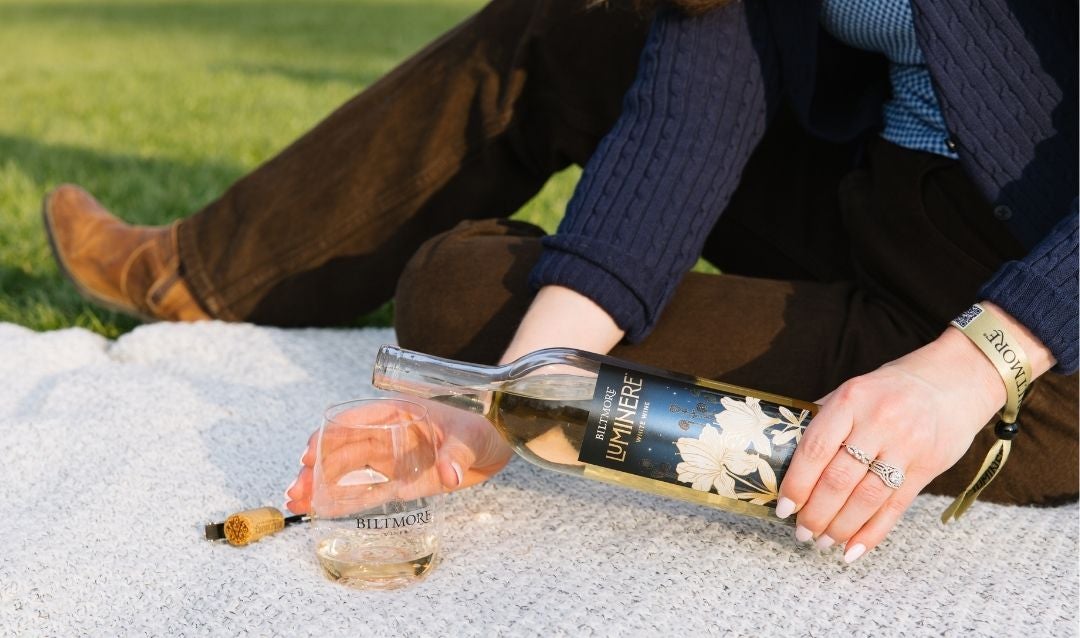 Luminere White Wine being poured into a glass for an outdoor picnic.