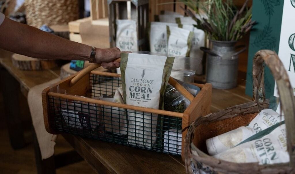 Packages of Biltmore Grown Corn Meal and Grits in a basket