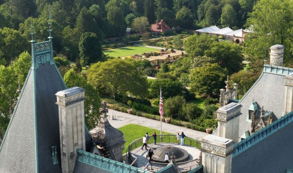 Drone view of Biltmore House Rooftop Tour with guests around the flag pole