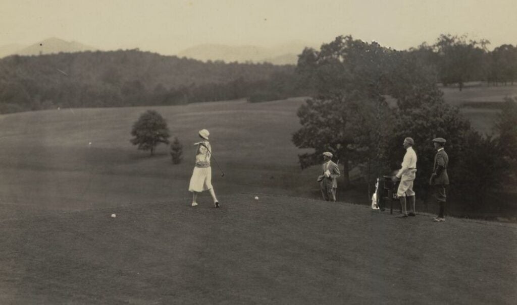 Archival photo of Cornelia Vanderbilt hitting a golf ball at the July 4, 1922 opening of Biltmore Forest Country Club.