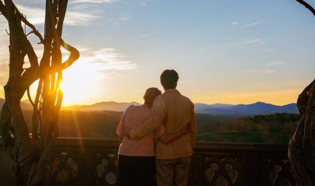 Couple watches the sunset at Biltmore.