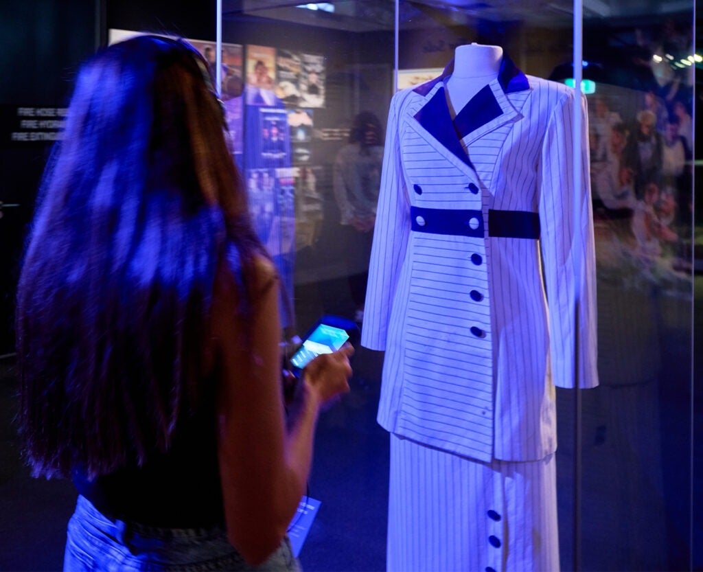 Silhouette of a girl looking at authentic costume from 1997 Titanic film